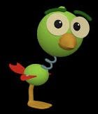 a green bird with big eyes standing in the dark