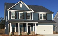 a two story house with blue siding and white trim