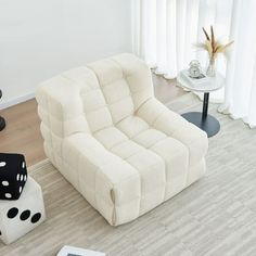 a living room with a chair and two dices on the floor next to each other