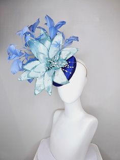 From the 2024 Featured Milliner of the Kentucky Derby Museum  kentucky derby hat fascinator royal blue satin with periwinkle blue feathers and large light blue velvet flower with white pearl decor stretch headband attachment  each hat is totally one of a kind! no two are alike! I can probably add feathers, flowers etc to existing hats for a small fee. I cannot remove anything from existing hats. Just message me and see if we can make it work! :) I cannot make custom order from scratch. My schedu Blue Mini Hats With Handmade Flowers For Royal Ascot, Blue Fascinator With Handmade Flowers For Kentucky Derby, Blue Handmade Flowers Fascinator For Races, Blue Fascinator For Kentucky Derby Races, Blue Feathered Wedding Costume Hat, Blue Handmade Flowers Fascinator For Party, Blue Party Headpiece With Handmade Flowers, Blue Wedding Costume Hat With Feathers, Blue Feather Headpiece For Kentucky Derby