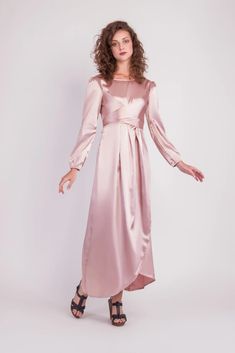 Feel more confident than ever before in the Satin Wrap Maxi Dress with Puff Sleeves that combines modesty with today’s most current modest fashion trends. The sleek satin maxi dress accentuates the waist with a luxurious wrap design while the puff sleeves accent a bold shoulder and feminine shape.Perfect for every special occasion, the unique dress comes in multiple colors to best fit your individual personality. Belted Floor-length Party Dress, Floor-length Belted Party Dress, Feminine Fitted Maxi Dress With Tie Waist, Elegant Pink Belted Maxi Dress, Evening Maxi Dress With Tie Waist, Modest Floor-length Maxi Dress For Evening, Chic Pink Belted Maxi Dress, Long Sleeve Maxi Dress With Side Slits For Evening, Modest Maxi Dress For Evening