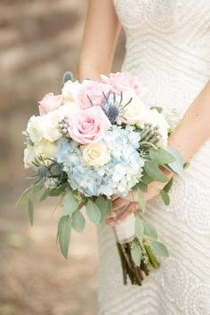 a bride holding a bouquet of flowers in her hands