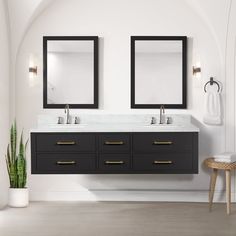 a bathroom with two sinks and mirrors on the wall next to a plant in a pot