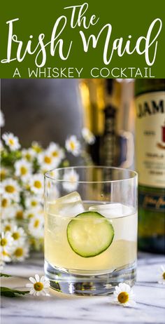 the irish maid a whiskey cocktail with cucumbers and daisies in front of it