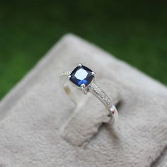 * Material: 925 Sterling Silver * DETAILS ✥ Handmade Ring ✥ - Center Stone: Lab Blue Sapphire  - Center Stone Size: 6 MM - Center Stone Shape: Cushion  - Side Stone: CZ Diamond  ✥ O T H E R ∙ I N F O R M A T I ON ✥ ♦ Your item will be nicely packed to gift in elegant jewelry boxes. ♦ Custom Order We can make custom rings in almost any shape and style. If you want a specific model, please send us a clear picture and we will do our best. ♦ Delivery All Item will be Shipped within 3 to 5 Days after Fine Jewelry Lab-created Sapphire Diamond Ring Gift, Lab-created Sapphire Diamond Ring Gift, Sapphire Crystal Ring Gift, Blue Topaz Jewelry With Halo Setting For Gift, Sapphire Birthstone Promise Jewelry, Adjustable Sapphire Ring With Birthstone, Blue Topaz Jewelry With Halo Setting As A Gift, Sapphire Birthstone Jewelry For Promise, Fine Jewelry Sapphire Topaz Ring Gift