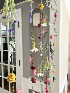 the flowers are hanging from the ceiling in front of the door and on the wall