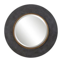 a round mirror sitting on top of a wall