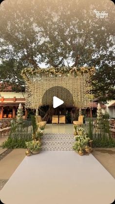 an outdoor ceremony setup with flowers and greenery