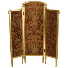 an ornately decorated screen with gold trimmings and floral designs on the sides