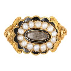 Antique Georgian era memorial ring (circa 1825) crafted in 18 karat yellow gold.   Natural pearls measuring (average) 2.5mm border an oval compartment that holds natural hair. The pearls are in very good condition showing good lustre. The glass case protecting the braided hair is in excellent condition and free of cracks or crisps.       The ring is a wonderful example of Georgian era memorial jewellery with rich floral and scrolled details to the side shoulders. The pearls border a lock of hair Regency Clothing, Memory Art, Victorian Hair, Lock Of Hair, John Wilson, Georgian Jewelry, Memorial Ring, Georgian Era, Momento Mori