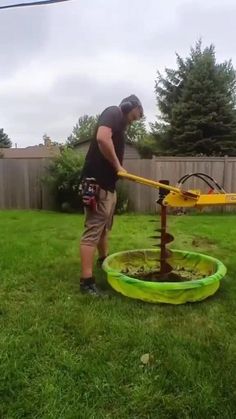 a man is using a lawn mower to cut grass