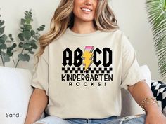 kindergarten, back to school, elementary school, teacher gift, gift for teacher, preschool teacher, teacher appreciation, kindergarten teacher, teacher shirt, new teacher gifts, kindergarten shirt, graduation shirt, teacher tee, kindergarten tshirt, teacher tshirts, kindergarten teacher shirt, preschool shirt, teacher team shirt, teacher life shirt, abcd teacher shirt, teachers day shirt, kindergarten tee, retro teacher shirt, abcd kindergarten rocks tshirts, abcd shirt, school shirt, kindergart Kindergarten Shirts For Teachers, Teacher Rocks, Kindergarten Teacher Outfits, Kindergarten Tshirt, Back To School Elementary, Kindergarten Teacher Gift, Teacher Preschool, Kindergarten Teacher Gifts, School Elementary