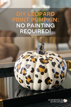 a painted pumpkin sitting on top of a table with the words diy leopard print pumpkin no painting required