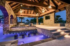 an outdoor hot tub with lights on the ceiling and steps leading up to it's entrance