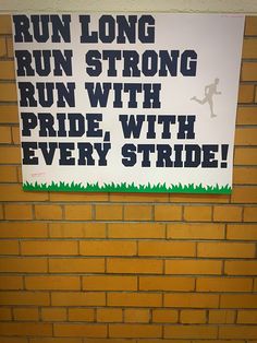 a sign posted on the side of a brick wall that says run long, run strong, run with pride, and every stride