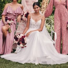 the bride and her bridesmaids are posing for a photo in their wedding gowns