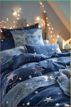 a bed with blue sheets and stars on it