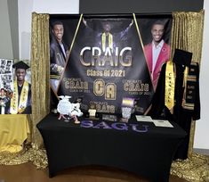 a table with some graduation decorations on it and two posters behind it that say craig class of 2021