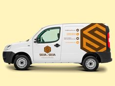 a white van with an orange and black design on the side is parked in front of a yellow background