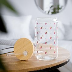 a glass vase with strawberries on it next to a wooden paddle