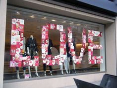 a store front with the word sale spelled out in red letters