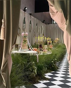 an elaborately decorated table in the middle of a checkerboard floored room