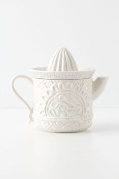 a white ceramic tea pot with a lid