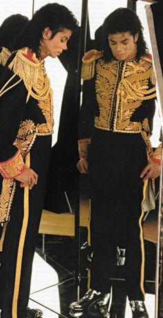 two men dressed in black and gold standing next to each other