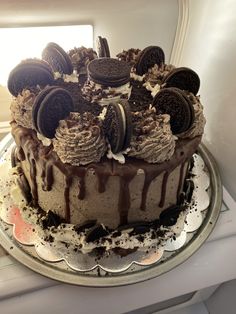 a cake with oreo cookies and chocolate frosting sitting on top of a table