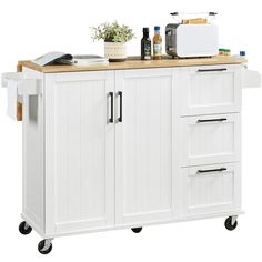 a white kitchen island cart with wood top and drawers on casteors is shown against a white background