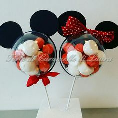 two mickey mouse lollipops with bows on them