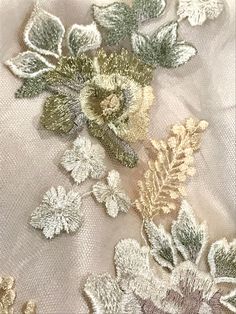 "This embroidered tulle is gorgeous! The rose design is embroidered in ivory and pale lilac. The leaves are ivory and sage green. The lilies are pale beige/ cream. Some of the roses are also pale beige/ cream with metallic gold. The tulle is a pale grayish-beige. This fabric is not scalloped on the edges. The design runs from selvedge to selvedge. I personally feels it's better for appliquéing. In the photos it is lined with a gold chiffon. Sold by the panel- this includes 3 full rows of design- Cotton Dress Fabric, Floral Dress Design, Pale Beige, Pale Lilac, Bead Embroidery Patterns, Embroidered Tulle, Boutique Dress Designs, My Sewing Room, 자수 디자인