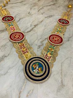 an elaborate necklace is displayed on a marble surface