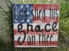 a sign that says god shed his grace on the flag