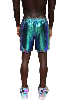 These iridescent snakeskin print green rave shorts are as comfy as they are captivating! Made with high quality four way stretchy nylon they are quick drying and perfect for getting down on the dancefloor. Two side zipper pockets ensure your stuff stays safe and secure while you're having fun. The rainbow reflective panels are an added bonus and excellent for glowing in flash photography. FEATURES: Made with high quality four way stretch Viper, iridescent green snakeskin print spandex Accent sid Metallic Stretch Disco Shorts, Metallic Disco Shorts For Summer, Neon Rave Outfits Men, Metallic Rave Bottoms For Summer, Summer Rave Metallic Bottoms, Iridescent Stretch Bottoms For Summer, Galactic Disco, Rainy Festival Outfit, Neon Rave Outfits