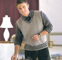 a man standing in front of a cake with candles on it and holding a knife