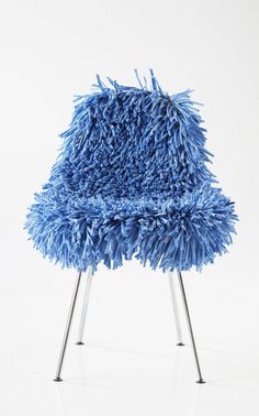 a blue chair that is sitting on some metal legs and it looks like something out of space