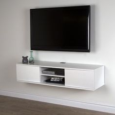 a flat screen tv mounted to the side of a white entertainment center in a living room