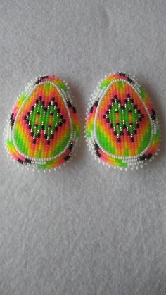 two pieces of beaded fabric with designs on them