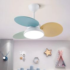 the ceiling fan is hanging from the ceiling in the children's room with colorful decorations