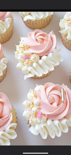 cupcakes with pink frosting and flowers on them