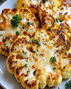 cooked cauliflower on a white plate with parsley