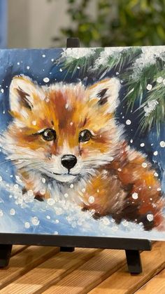 a painting of a red fox sitting in the snow with pine tree branches behind it