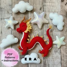 a red dragon sitting on top of a wooden floor next to stars and clouds with the word era written below it