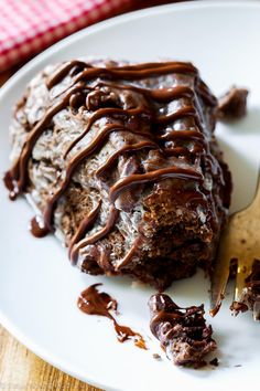 a piece of chocolate cake on a plate with a fork