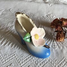 a ceramic shoe with a flower on it