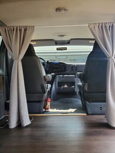 the interior of a vehicle with curtains open