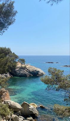 the water is crystal blue and clear with some rocks on it's side,