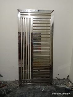 an open metal door sitting in the middle of a room