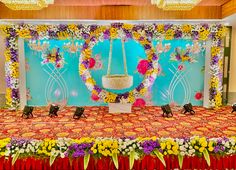 an arrangement of flowers and decorations on a stage